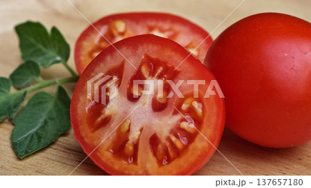 Fresh red tomatoes in a wooden plate. Fresh red tomatoes in a wooden plate. 137657180