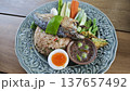 Thai fried rice with shrimp paste, topped with fried mackerel, vegetables, and egg. 137657492
