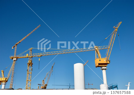 Yellow shipyard crane towering under clear blue sky in Vigo industrial port Yellow shipyard crane towering under clear blue sky in Vigo industrial port 137657588