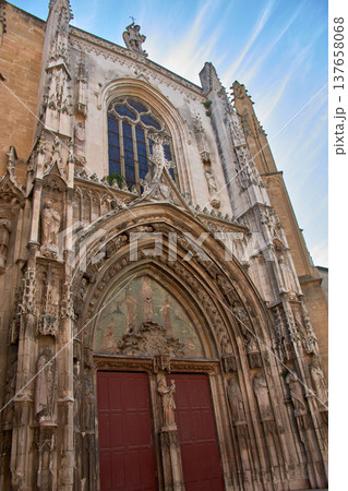The imposing entrance of Saint Sauveur Cathedral, Aix-en-Provence, with its sculpted portal and stained-glass window. The imposing entrance of Saint Sauveur Cathedral, Aix-en-Provence, with its sculpted portal and stained-glass window. 137658068