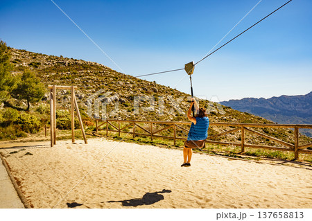 Adult woman having fun on zipline 137658813