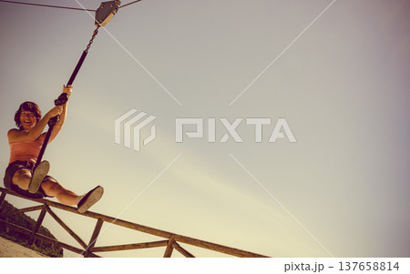 Adult woman having fun on zipline 137658814