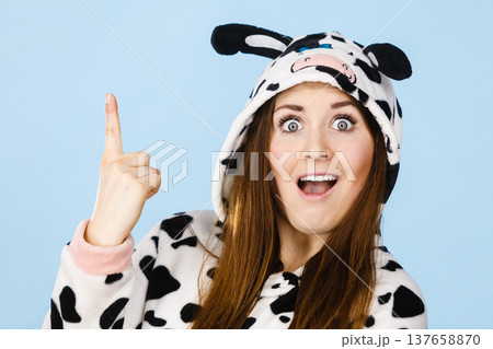 Woman wearing pajamas cartoon pointing up 137658870