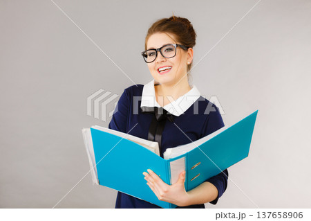 Happy positive business woman holding binder with documents 137658906