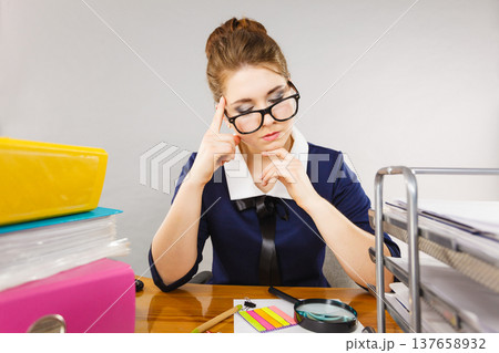 Business woman in office being focused Business woman in office being focused 137658932