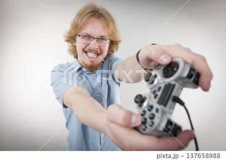 Gamer man holding gaming pad Gamer man holding gaming pad 137658988