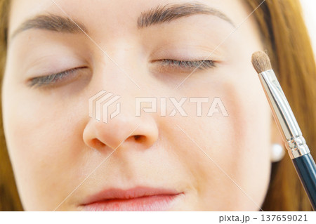 Makeup artist applying eye make up 137659021