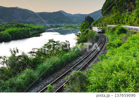 宮崎県日南市北郷町の広渡川の新緑を走る日南線キハ40 137659090