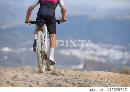 Mountain biker in action on a stone trail concept for healthy lifestyle, exercise and extreme sports. View from the back Mountain biker in action on a stone trail concept for healthy lifestyle, exercise and extreme sports. View from the back 137659707