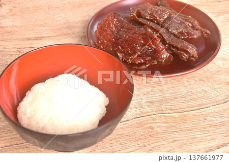salty and sweet dry fried slice beef meat fermenting in sesame oil and pepper on plate eat couple sticky rice 137661977