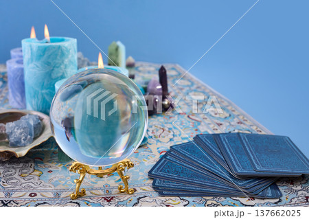 Crystal ball with tarot cards and burning candles 137662025