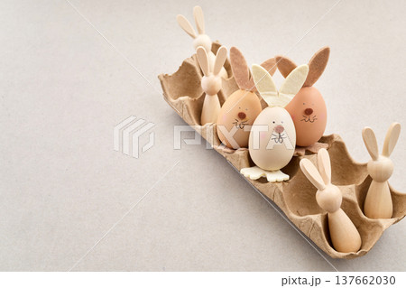 Zero waste Easter. Easter egg bunnies and wooden figures in carton 137662030