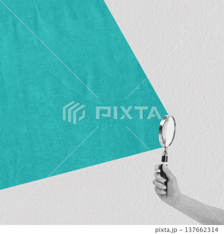 Hand holding magnifying glass exploring colorful textured background 137662314