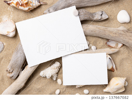 Blank cards mockup on sand with seashells and driftwood, summer wedding and beach event graphic Blank cards mockup on sand with seashells and driftwood, summer wedding and beach event graphic 137667082