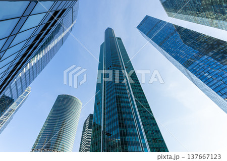 Modern glass skyscrapers on a clear day. Business center of a big city Modern glass skyscrapers on a clear day. Business center of a big city 137667123