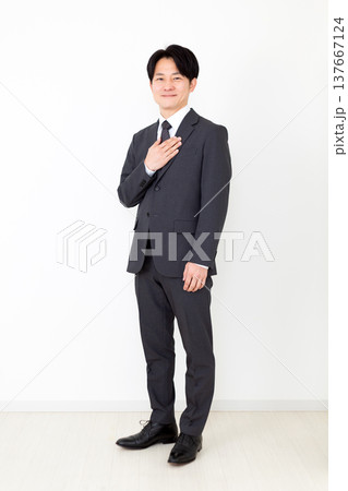 胸に手を当てるスーツを着たミドル男性ビジネスマン 137667124