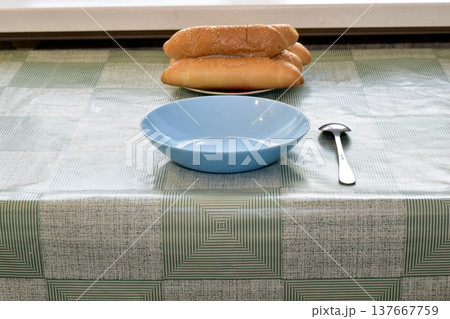 There is a blue plate on the table. 137667759