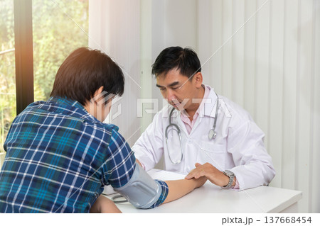 Doctor examining patient pulse by hands. Healthcare and medical service. 137668454