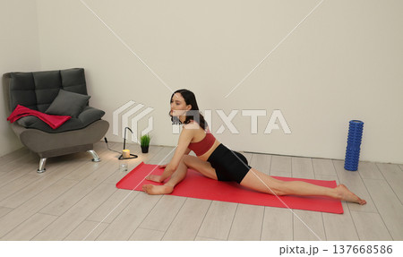 Yoga practice in a serene indoor space with a calm atmosphere and focused energy during evening hours 137668586