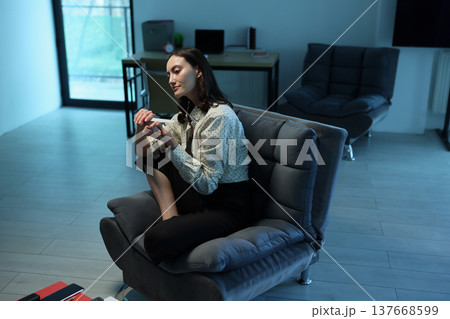 Cozy afternoon in a modern living space with a woman enjoying quiet time and creative expression Cozy afternoon in a modern living space with a woman enjoying quiet time and creative expression 137668599