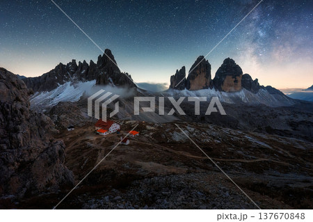 Scenic view of Milky way over Tre Cime mountain peak and mountain hut in the night at Dolomites, Italy 137670848