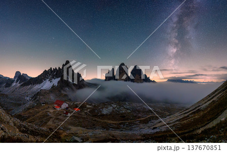 Scenic view of Milky Way over Tre Cime di Lavaredo mountain and Rifugio Locatelli at night in Dolomites, Italy 137670851