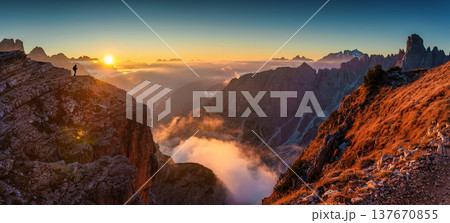 Golden sunrise over rocky mountain peak in Cadini di Misurina at Dolomites, Italy Golden sunrise over rocky mountain peak in Cadini di Misurina at Dolomites, Italy 137670855