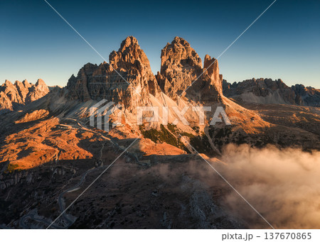 Scenic view of rugged Tre Cime di Lavaredo mountain and foggy in the morning at Dolomites, Italy Scenic view of rugged Tre Cime di Lavaredo mountain and foggy in the morning at Dolomites, Italy 137670865
