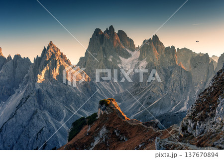 Alpine landscape of Cadini di Misurina with rugged mountain range during sunset in Dolomites, Italy Alpine landscape of Cadini di Misurina with rugged mountain range during sunset in Dolomites, Italy 137670894