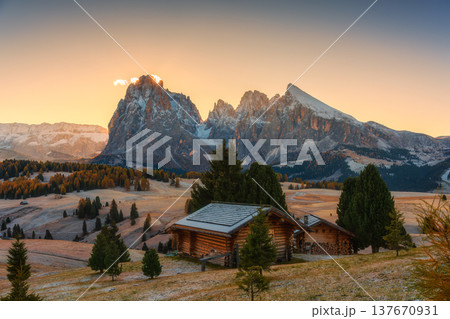 Scenic view of Alpe di Siusi with autumn rolling hill and rustic huts during morning in Dolomites, Italy 137670931