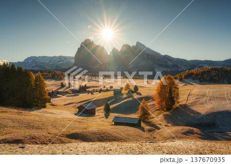 Scenic view of Alpe di Siusi with wooden huts, trees on alpine meadow during autumn in Dolomites, Italy 137670935