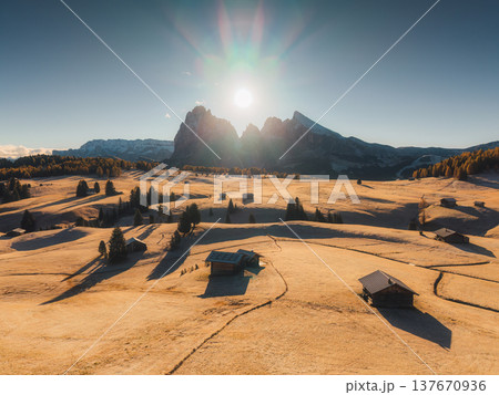 Scenic view of Alpe di Siusi with autumn rolling hill and rustic huts during morning in Dolomites, Italy Scenic view of Alpe di Siusi with autumn rolling hill and rustic huts during morning in Dolomites, Italy 137670936
