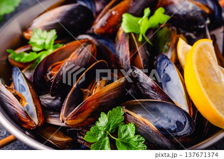 Delicious seafood mussels with sauce and parsley. Delicious seafood mussels with sauce and parsley. 137671374