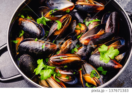 Delicious seafood mussels with sauce and parsley. Delicious seafood mussels with sauce and parsley. 137671383