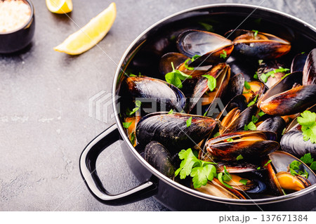 Delicious seafood mussels with sauce and parsley. Delicious seafood mussels with sauce and parsley. 137671384