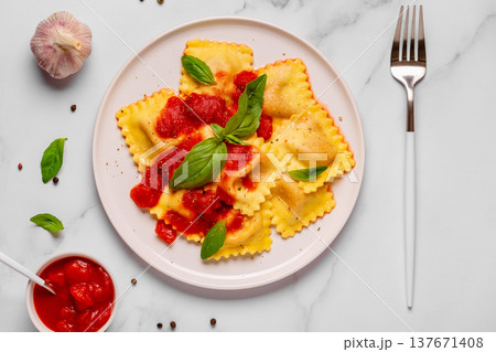 Delicious appetizing ravioli with tomato sauce and basil Delicious appetizing ravioli with tomato sauce and basil 137671408