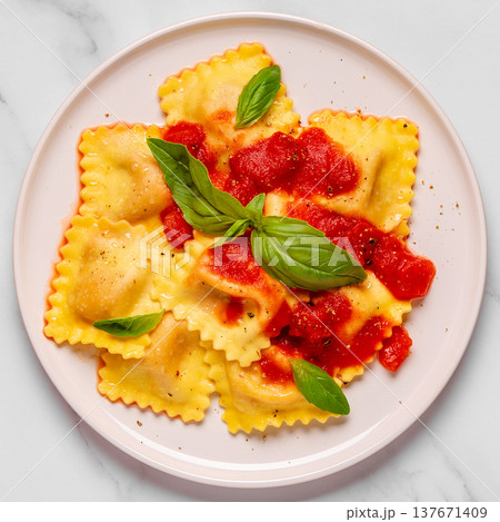 Delicious appetizing ravioli with tomato sauce and basil 137671409