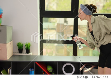 Cleaning and freshening up a cozy space in bright daylight Cleaning and freshening up a cozy space in bright daylight 137671633
