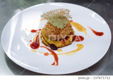 Gourmet dessert with breaded ice cream ball served on pineapple slice with fruit sauces Gourmet dessert with breaded ice cream ball served on pineapple slice with fruit sauces 137671712