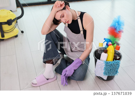 Cleaning day brings mixed emotions while preparing supplies and gathering thoughts in a bright modern home 137671839