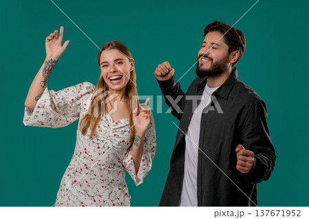 Positive Happy Young Couple Dancing. Green Studio Wall. Music, Dance, Party,love 137671952