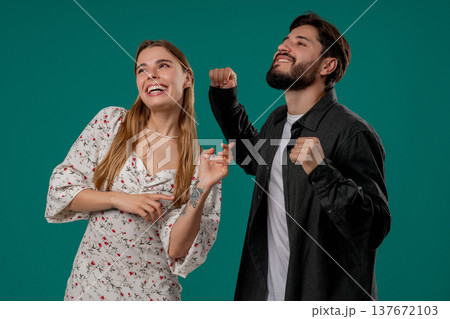 Positive Happy Young Couple Dancing. Green Studio Wall. Music, Dance, Party,love 137672103