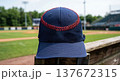 Baseball Cap with Red Stitching Detail on Stadium Background 137672315