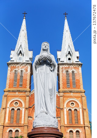 Virgin Mary statue standing in front of Notre Dame Cathedral Basilica of Saigon in Ho Chi Minh City, Vietnam. 137672478