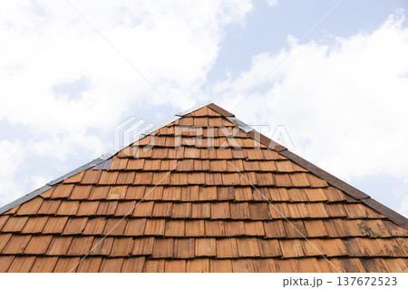 Close view of red roof tiles on residential house showing classic roofing construction 137672523
