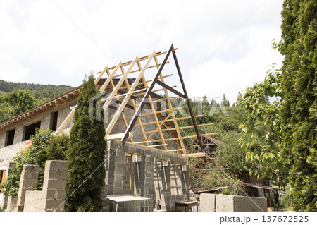 Wooden construction attached to a house in the mountains showing building extension and rural architecture 137672525