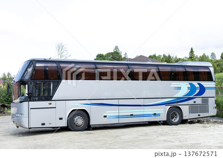 Grey passenger bus viewed from the side standing on a parking lot. Public transportation and travel concept 137672571
