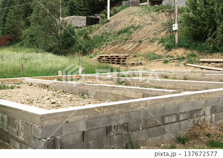 Groundwork and preparation for pouring house foundation at a residential construction site Groundwork and preparation for pouring house foundation at a residential construction site 137672577