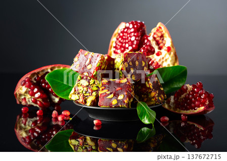 Turkish pomegranate delight with pistachio and pieces of fresh pomegranate. Turkish pomegranate delight with pistachio and pieces of fresh pomegranate. 137672715