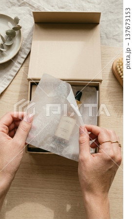 Hands Lifting Delicate Tissue Paper in Luxury Box Reveal Hands Lifting Delicate Tissue Paper in Luxury Box Reveal 137673153